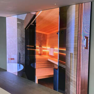 Large indoor LED display wall showing a vivid sauna scene, highlighting seamless aesthetic digital signage integration.