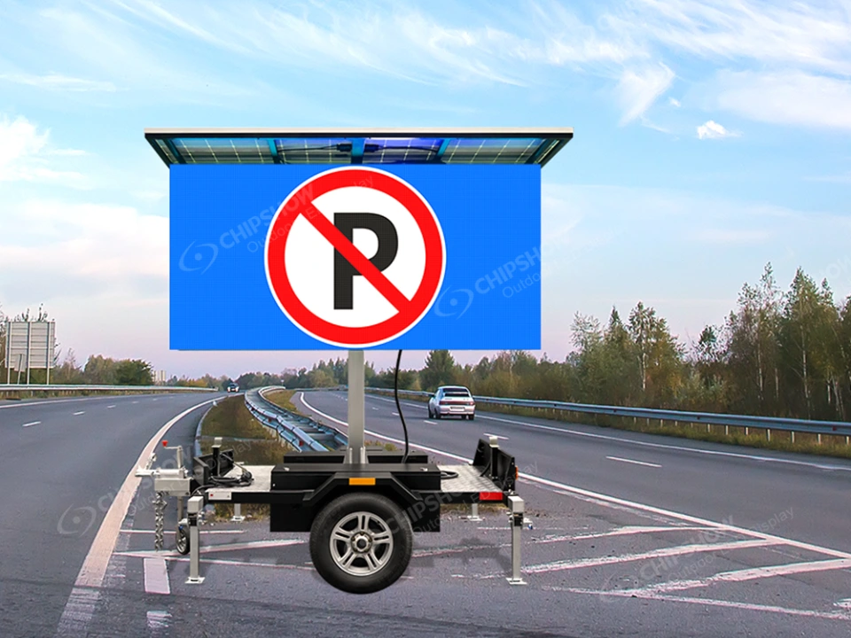 C-Tra-VMS solar trailer with LED traffic display showing a no parking sign on a highway roadside.