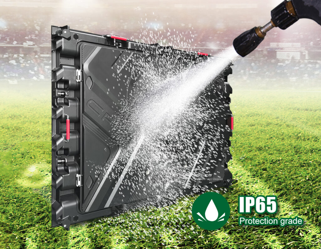IP65-rated LED display panel being pressure washed on a sports field, demonstrating waterproof weather resistance