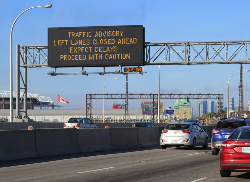 Highway gantry message sign displaying clear traffic guidance above a multilane road