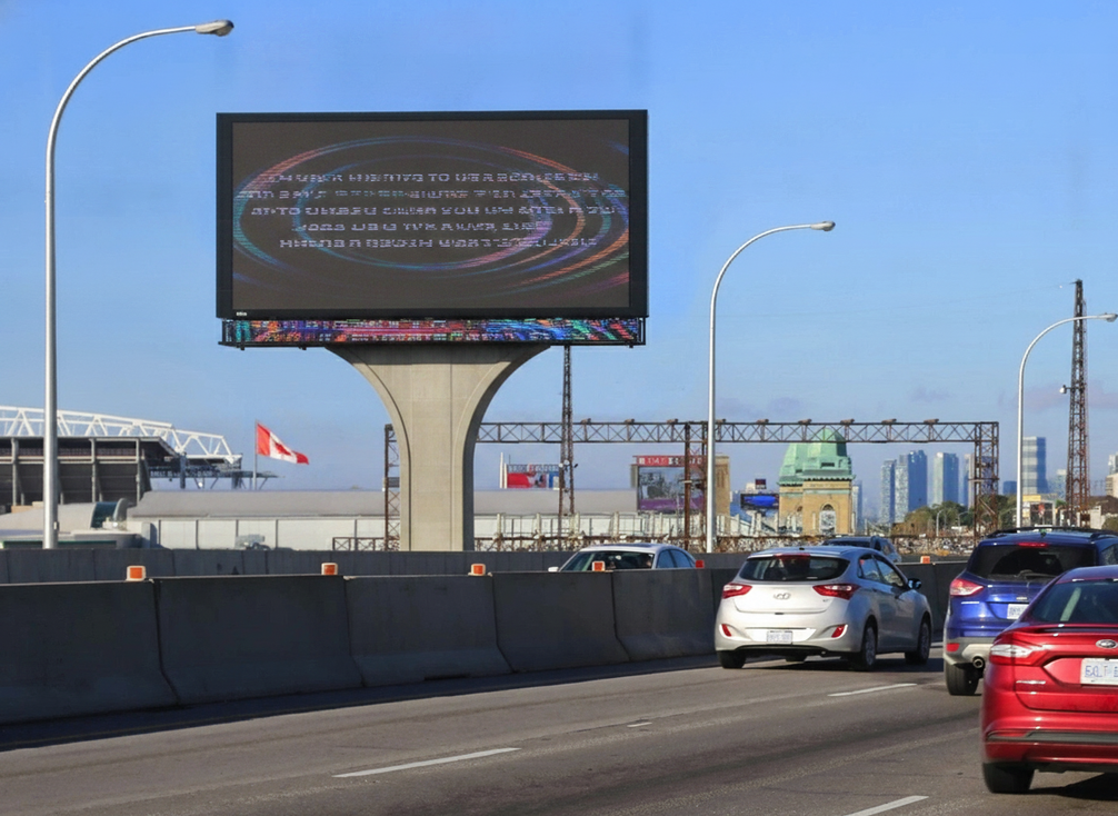 Municipal transit stop with a public safety LED display in an urban streetscape.