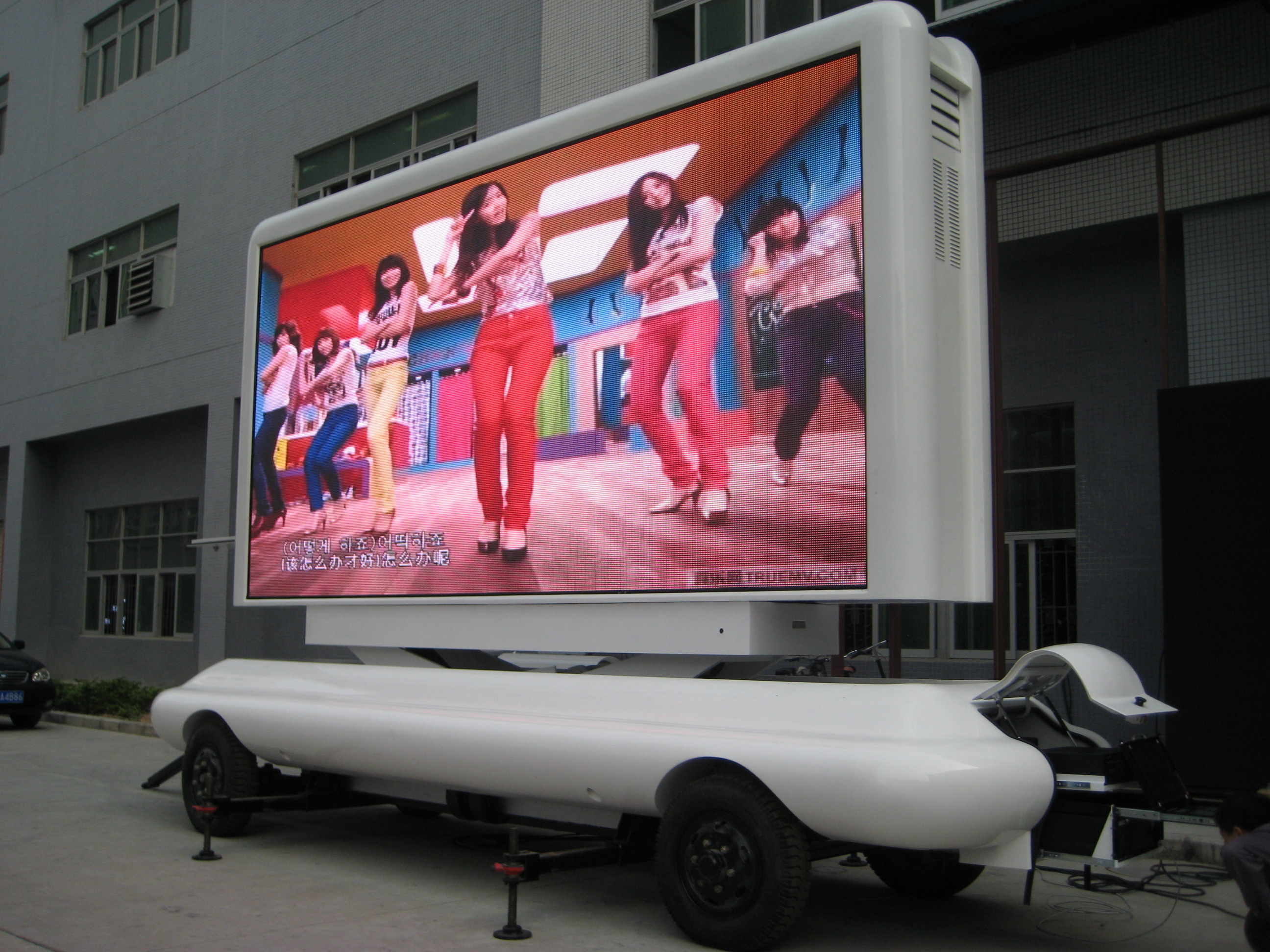 Mobile trailer-mounted LED message screen at an outdoor event