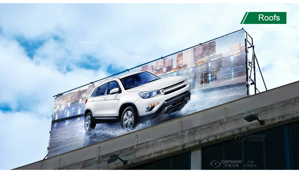 Large‑size rooftop outdoor LED billboard displaying white SUV car advertisement against city sky background