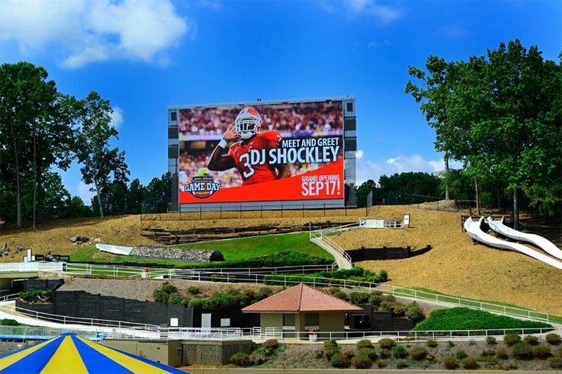 Large outdoor LED billboard at a stadium venue illustrating an outdoor digital billboard subject to weather and grid risks.