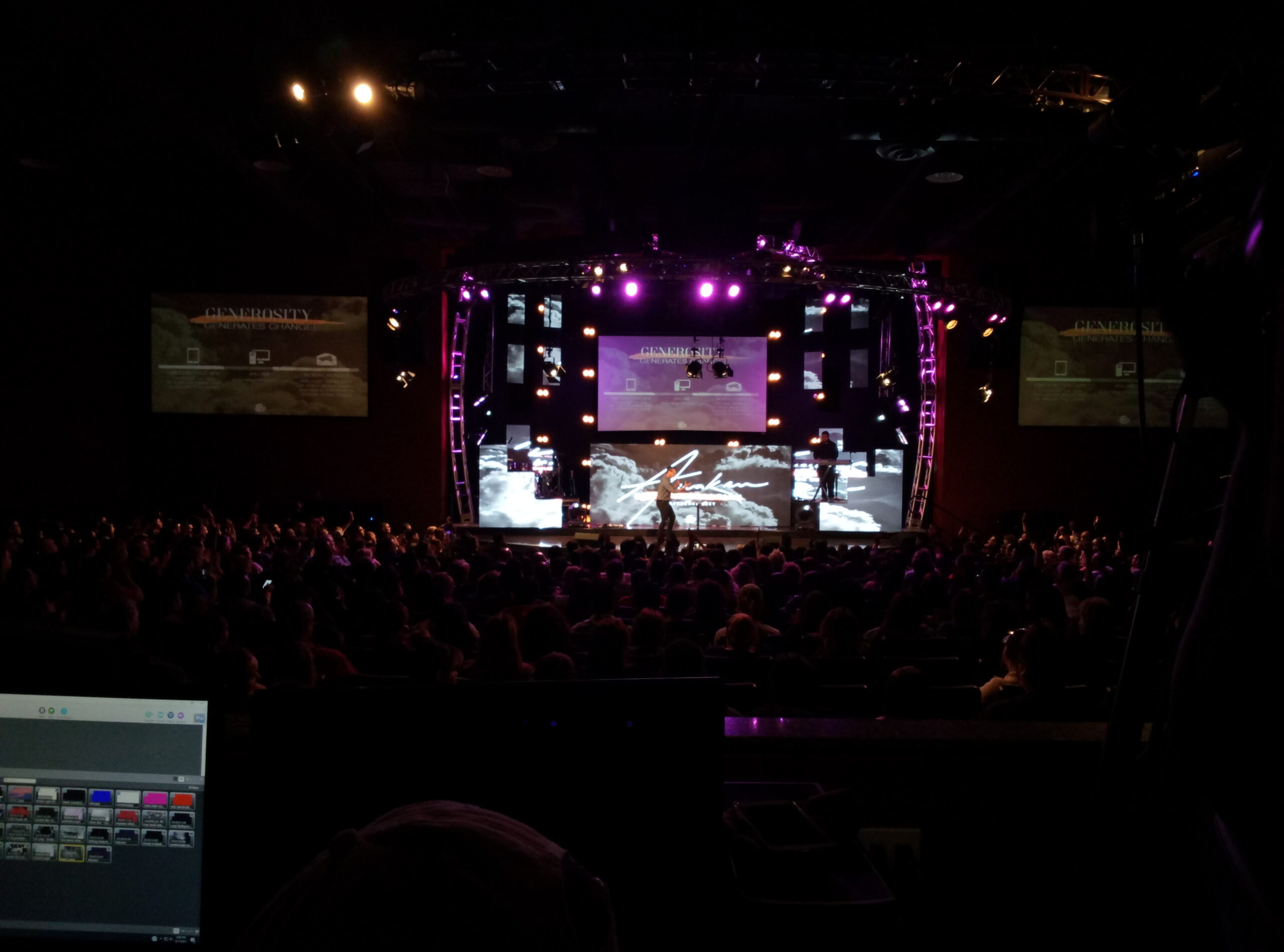 Indoor LED stage screen viewed from the control booth, illustrating the CMS and remote-monitoring perspective used to verify screen health.