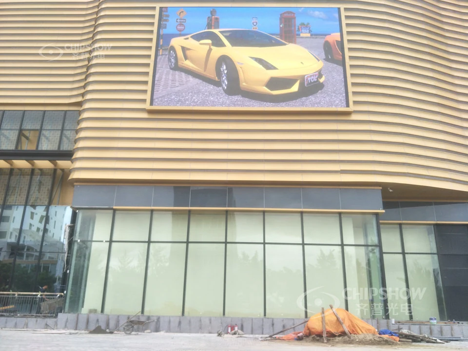 Outdoor LED billboard on a building facade displaying automotive advertising.