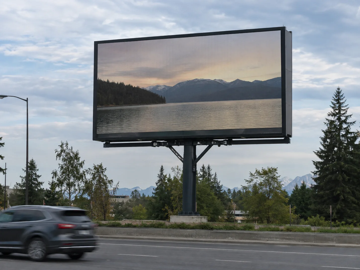 Concept scene: a realistic upright roadside LED billboard on a solid steel structure under open sky in daylight, screen showing a muted non-text scene or a dark/off screen; illustrative only, not a real installation, wind-load or structural record.